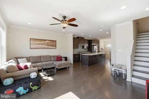 a living room with furniture and kitchen view
