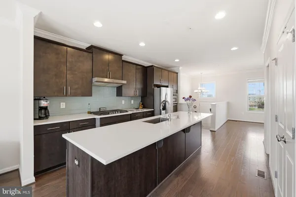a kitchen with a sink a stove a refrigerator and cabinets