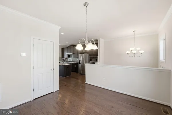 a view of a kitchen with a sink wooden floor and a kitchen view