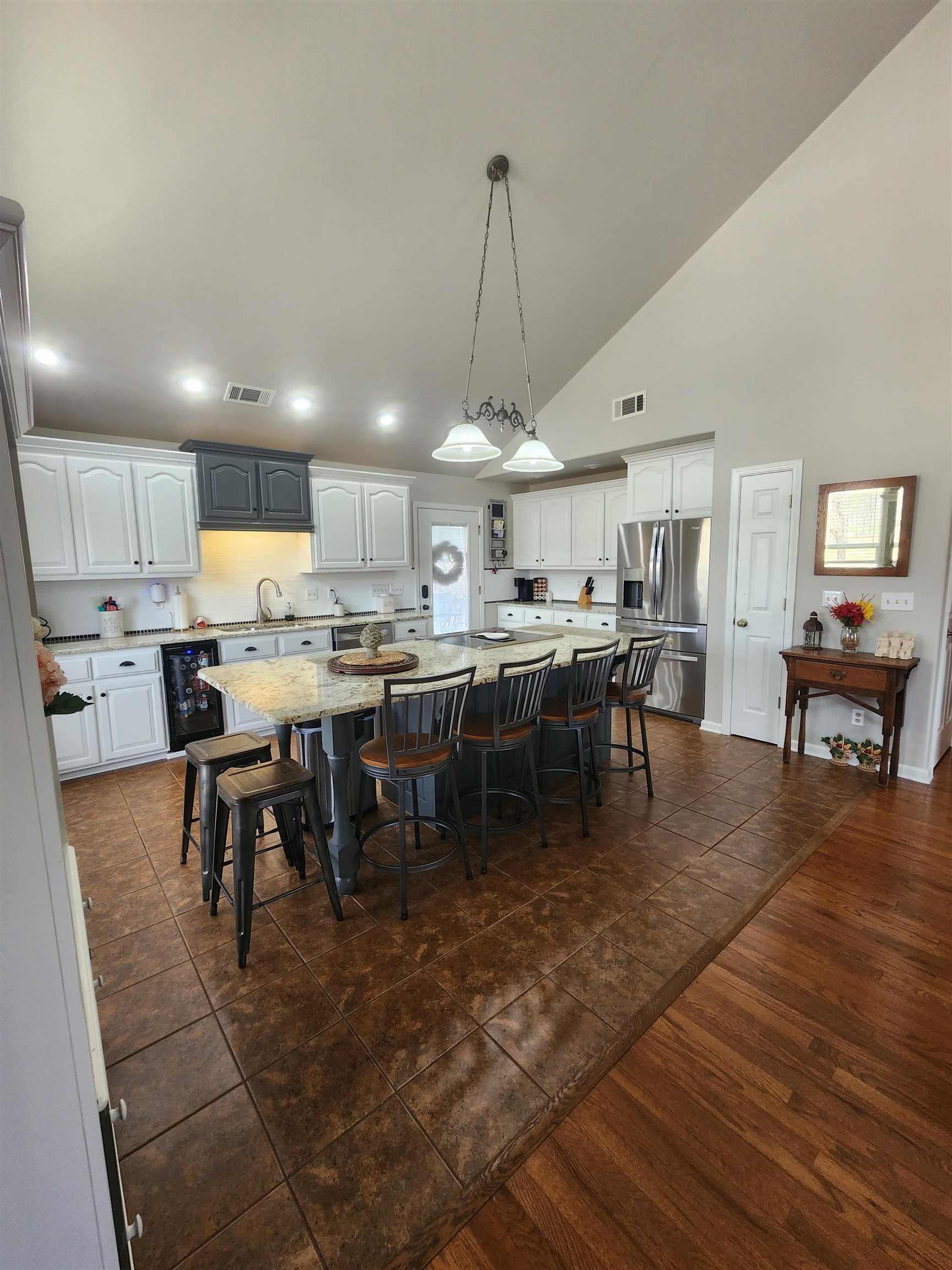 620 Old Road Counce, TN 38326 - Photo 12 of 32 a large dining hall with stainless steel appliances granite countertop a stove oven a dining table and chairs with wooden floor