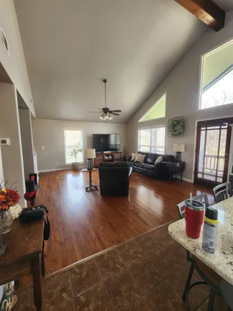 a large bed sitting in a bedroom next to a window and a chandelier
