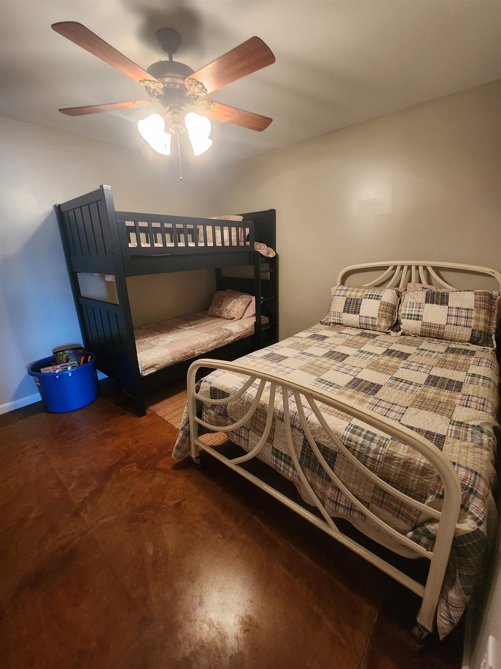 620 Old Road Counce, TN 38326 - Photo 27 of 32 a bedroom with a bed a lamp on the table and a chandelier