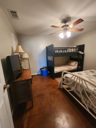 a bedroom with a bed and window