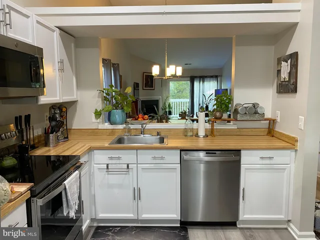a living room filled with furniture and a chandelier