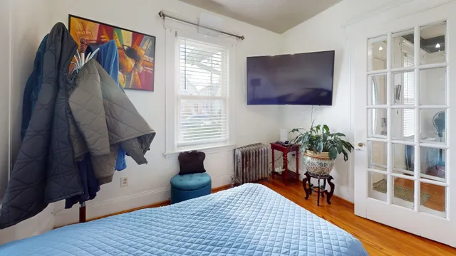 a bedroom with furniture and a window