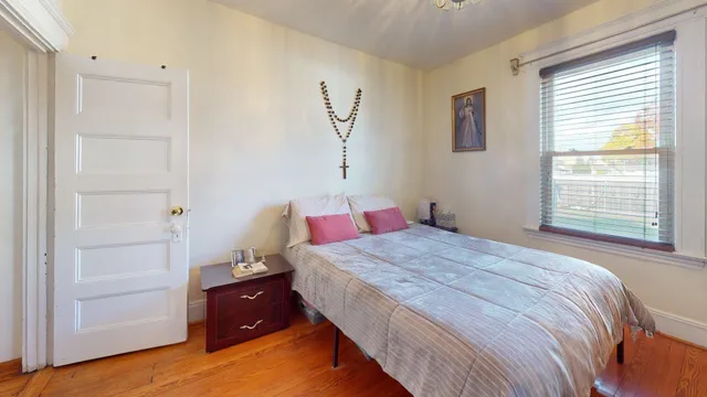 a bedroom with a bed and a window