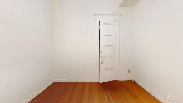 a view of a room with wooden floor