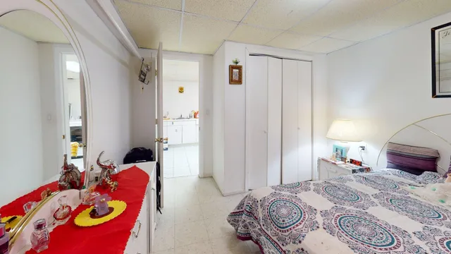 a bedroom with bed and a closet