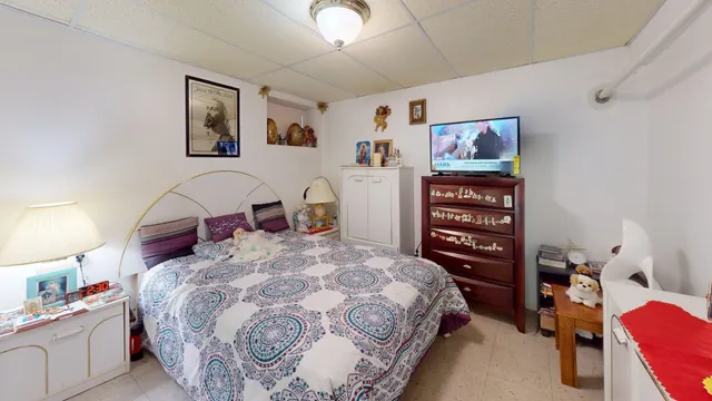 a bedroom with a bed and a dresser in it