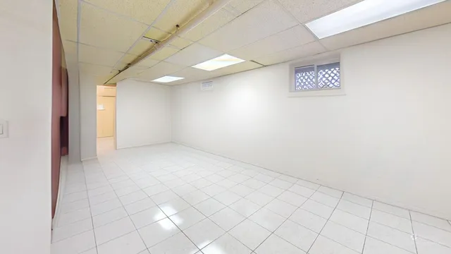 a spacious bathroom with a granite countertop sink a toilet and a mirror