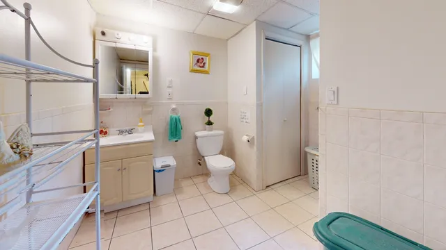 a bathroom with a toilet sink and a mirror