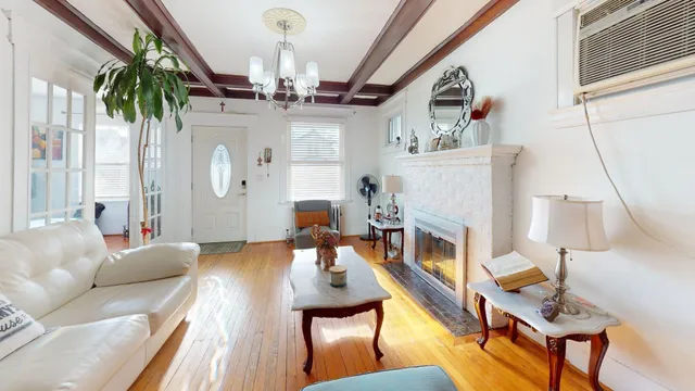 a living room with furniture fireplace and a large window