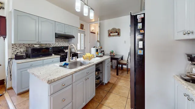 a kitchen with a sink stove and cabinets