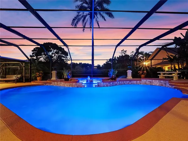 a view of a swimming pool with a table and chairs