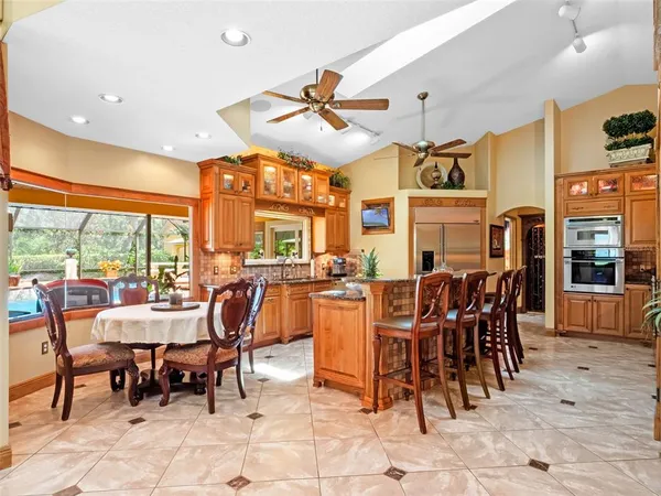 a kitchen with stainless steel appliances kitchen island granite countertop a sink and cabinets