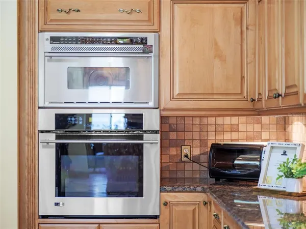 a dining room with furniture a rug and a floor to ceiling window