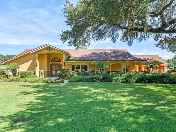 a front view of house with yard and green space