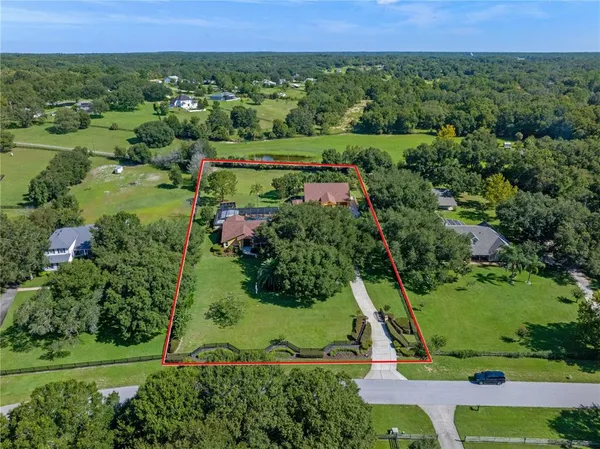 a view of a garden with a building in the background