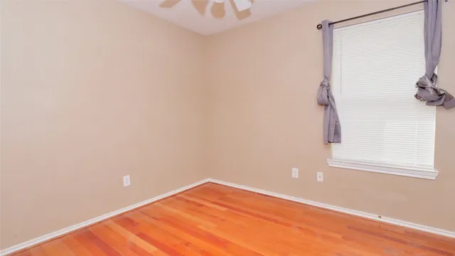 a view of a room with wooden floor and cabinet