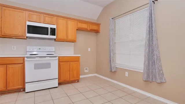 a kitchen with a stove and a microwave