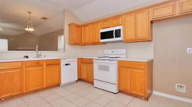 a kitchen with stainless steel appliances granite countertop a sink and cabinets