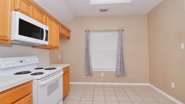 a kitchen with a stove and a microwave