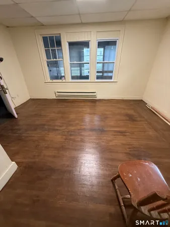 a view of room with window and wooden floor