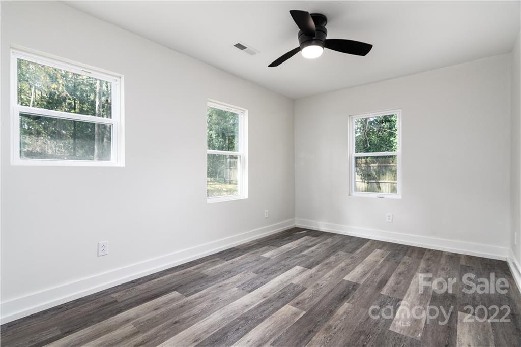 990 Dunlap Roddey Road Rock Hill, SC 29730 - Photo 18 of 28 a view of an empty room with wooden floor and a window