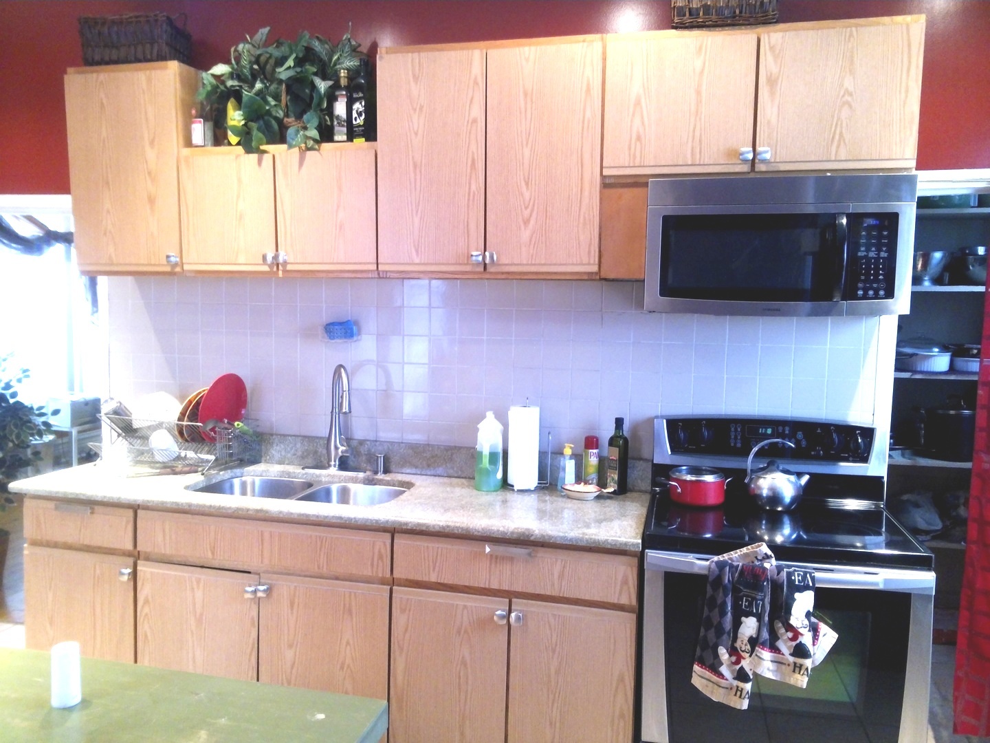 2665 East 77th Street Chicago, IL 60649 - Photo 20 of 46 a kitchen with stainless steel appliances a sink a stove and a microwave