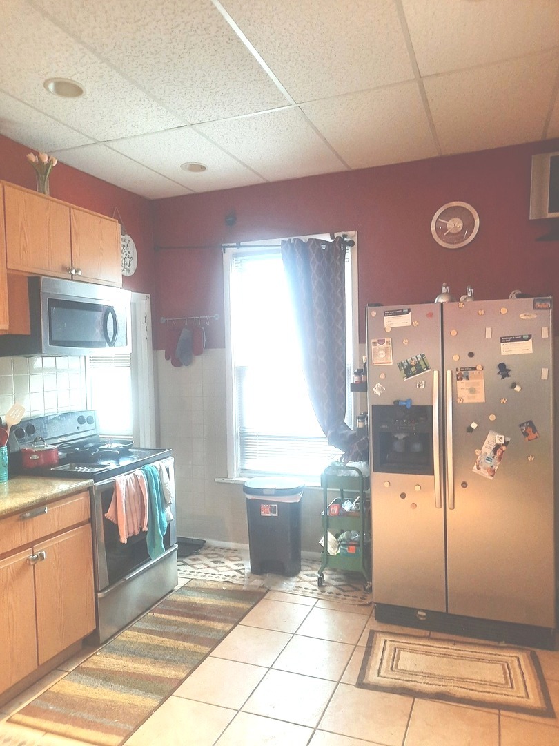 2665 East 77th Street Chicago, IL 60649 - Photo 23 of 46 a spacious bathroom with a glass shower door and a window