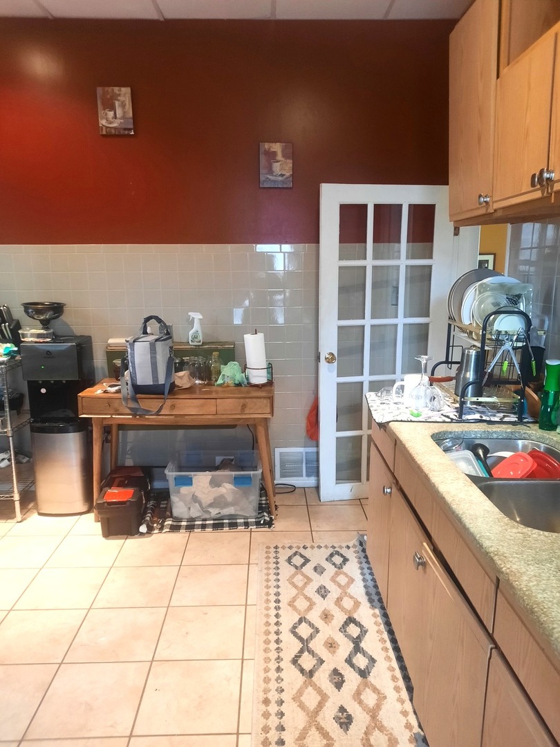2665 East 77th Street Chicago, IL 60649 - Photo 24 of 46 a kitchen with a sink and a stove top oven