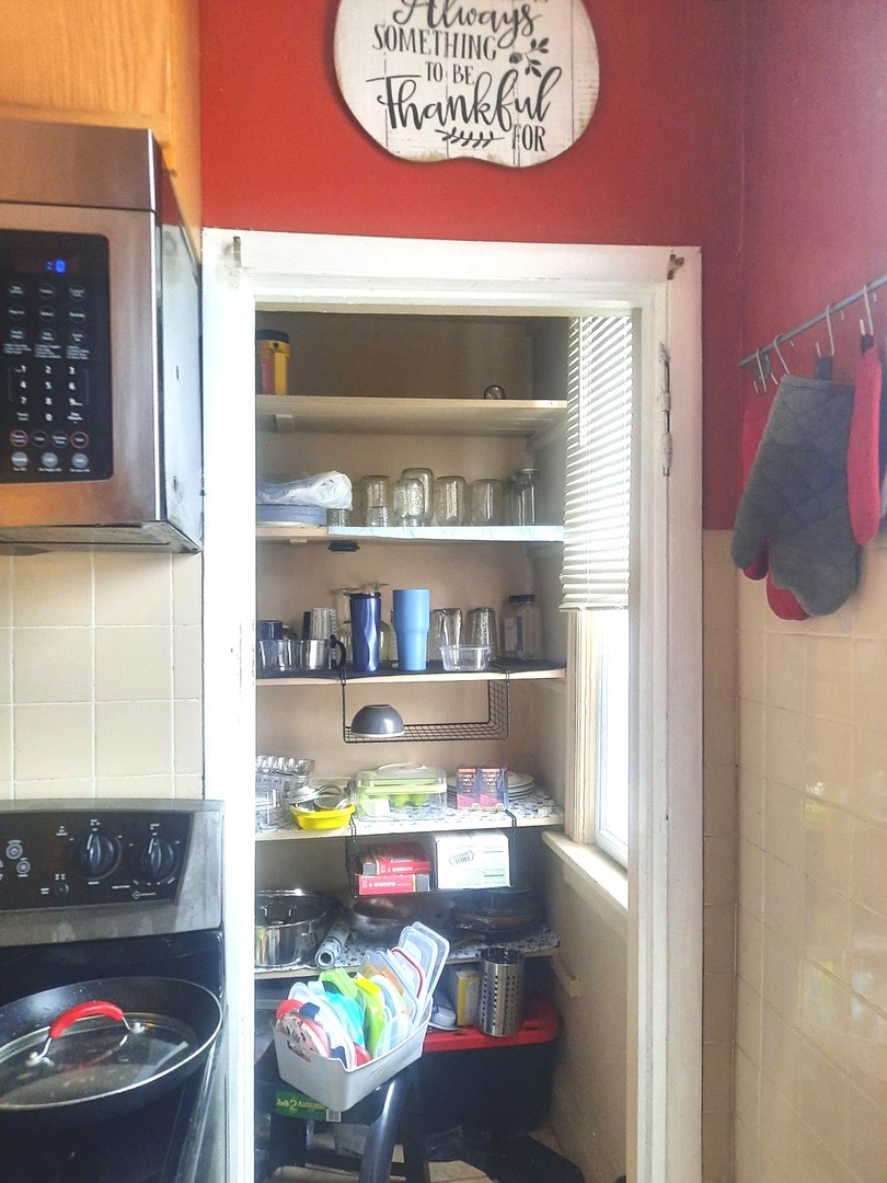 2665 East 77th Street Chicago, IL 60649 - Photo 25 of 46 a store room with stainless steel appliances kitchen island granite countertop a stove and a refrigerator