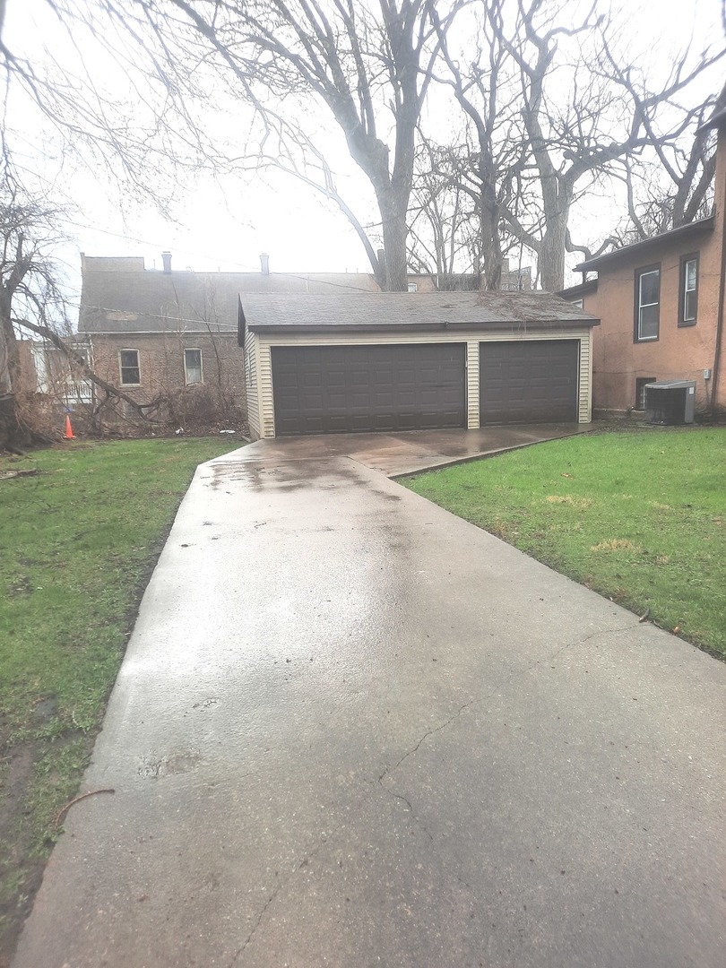 2665 East 77th Street Chicago, IL 60649 - Photo 4 of 46 front view of house with a yard and trees