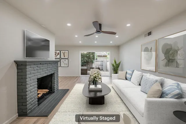 a living room with furniture a fireplace and a flat screen tv