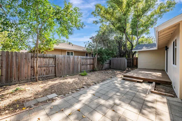 a backyard of a house with a tree