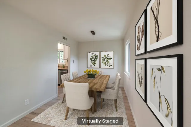a view of a dining room with furniture and a window