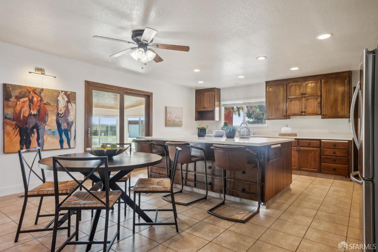 4355 Raymond Road Livermore, CA 94551 - Photo 17 of 74 a kitchen with a dining table chairs and white cabinets