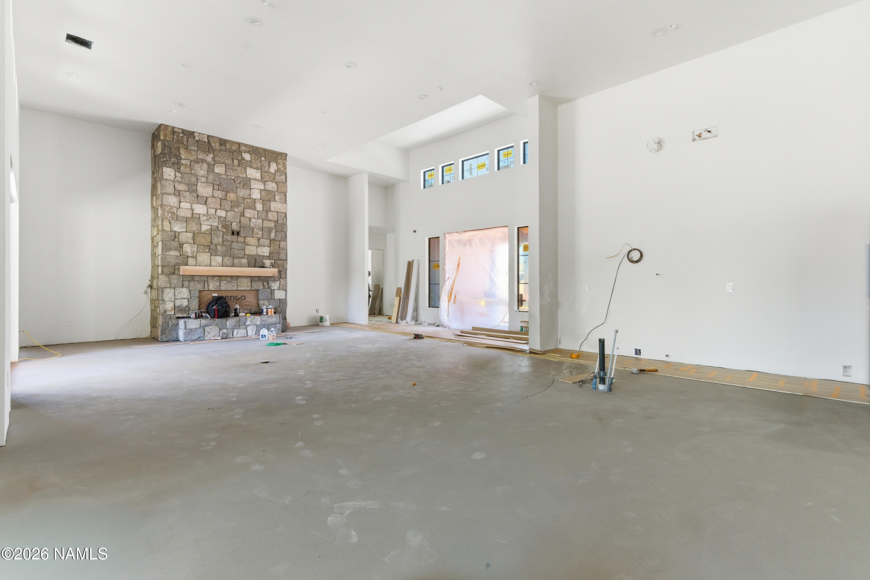 2380 East Del Rae Drive Flagstaff, AZ 86005 - Photo 5 of 26 wooden floor and window in an empty room