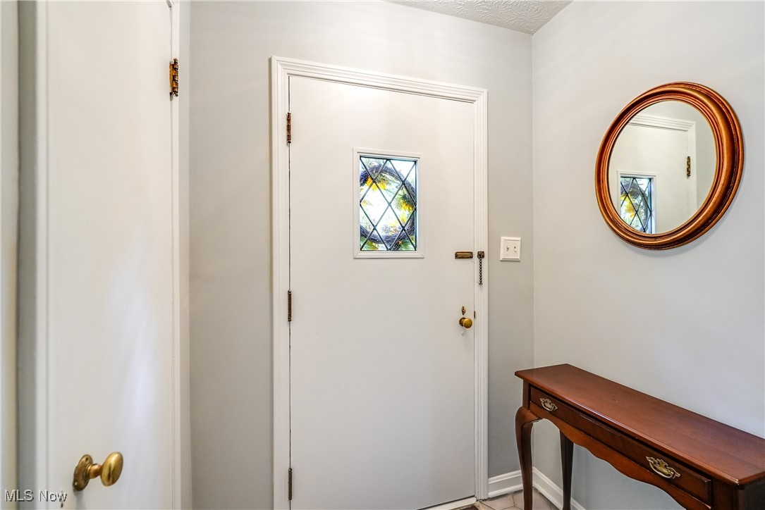 2488 Holgate Road Akron, OH 44313 - Photo 8 of 50 Welcoming front entry with tile floor, and convenient coat closet with brass doorknob.