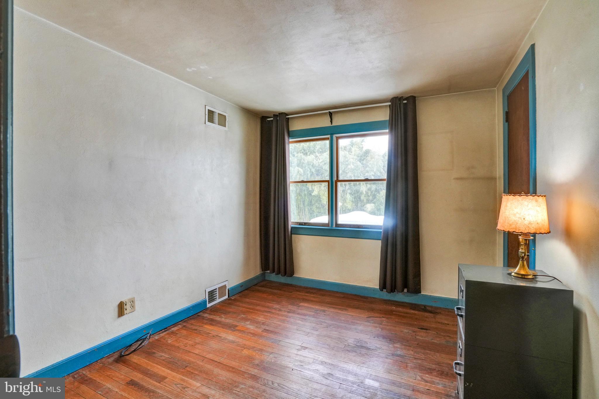 1211 Old Schuylkill Road Pottstown, PA 19465 - Photo 23 of 54 a view of an empty room with wooden floor and a window