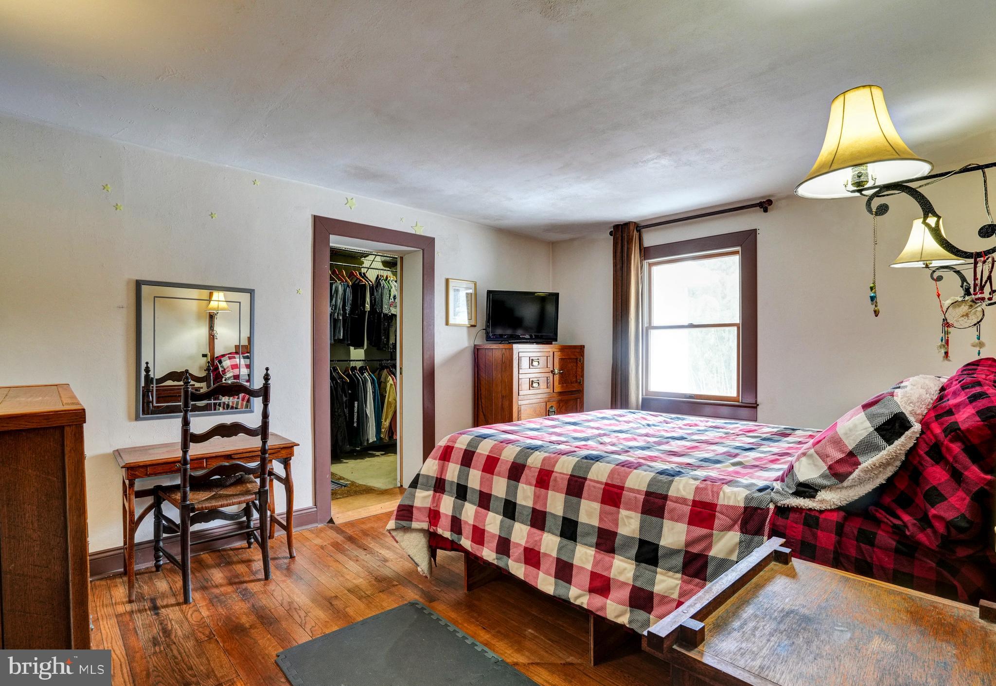 1211 Old Schuylkill Road Pottstown, PA 19465 - Photo 24 of 54 a bedroom with a bed and wooden floor