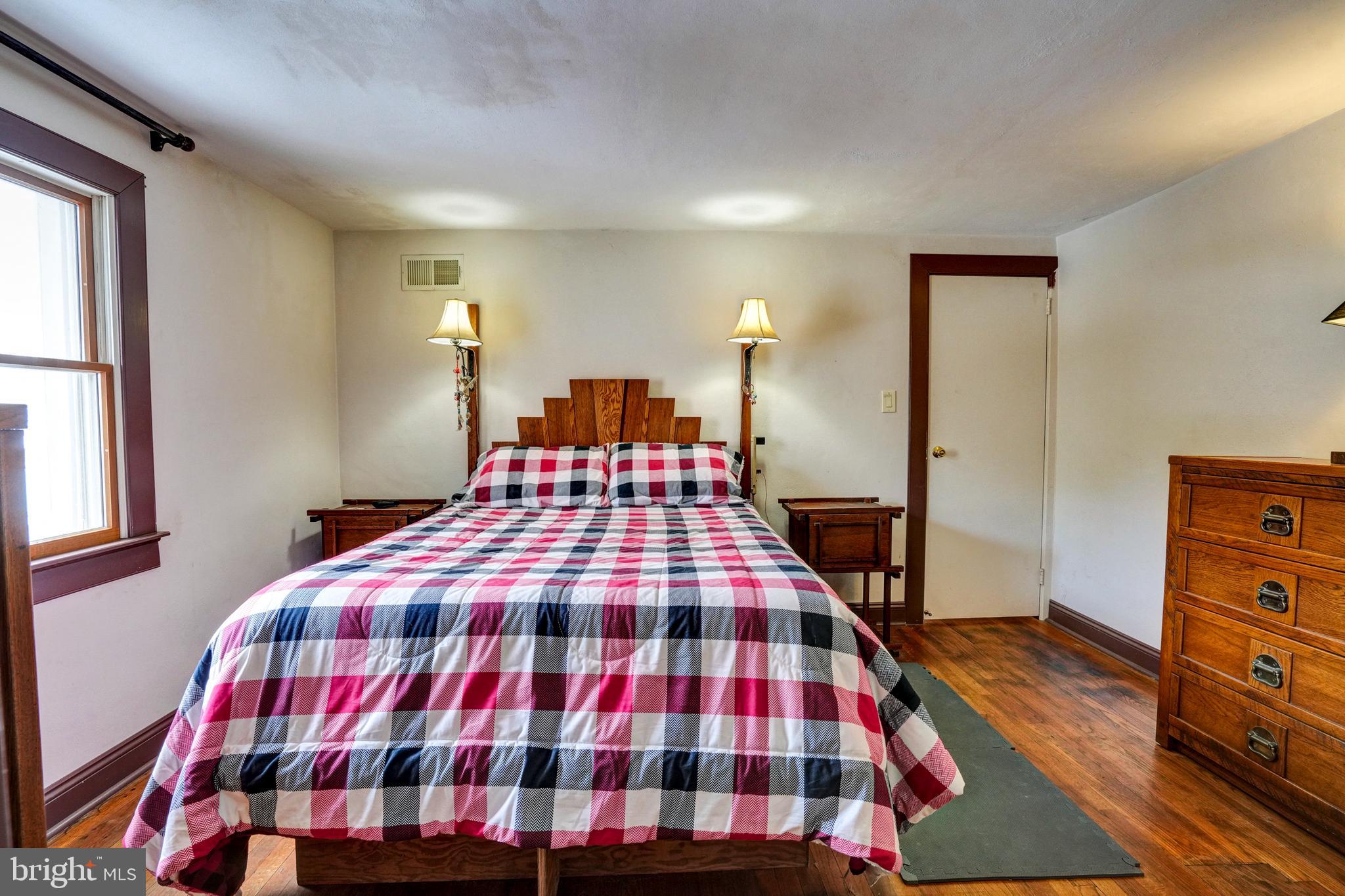 1211 Old Schuylkill Road Pottstown, PA 19465 - Photo 25 of 54 a bedroom with a bed and wooden floor