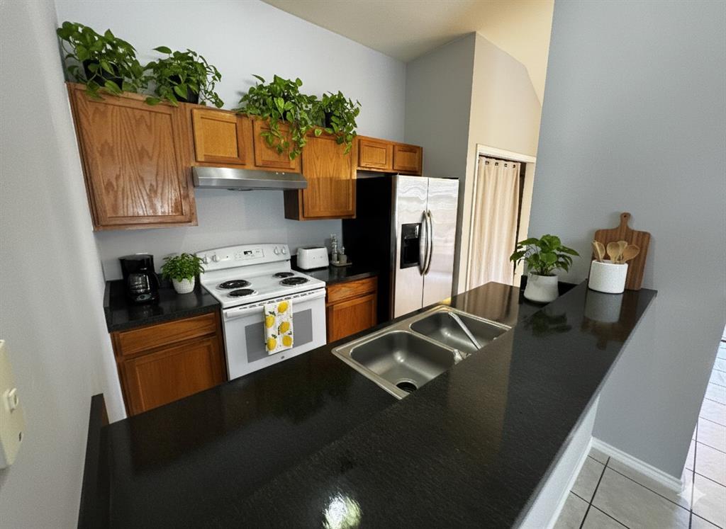 1707 Tina Marie Road, Unit A Arlington, TX 76012 - Photo 16 of 34 Kitchen with cabinets, stainless steel refrigerator with ice dispenser virtual staging