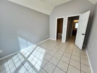 1707 Tina Marie Road, Unit A Arlington, TX 76012 - Photo 24 of 34 Bedroom featuring high ceilings, connected to primary bathroom