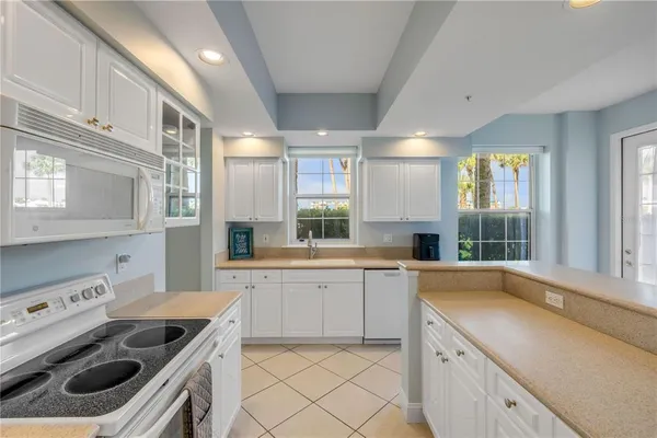 a kitchen that has a sink and a large window in it