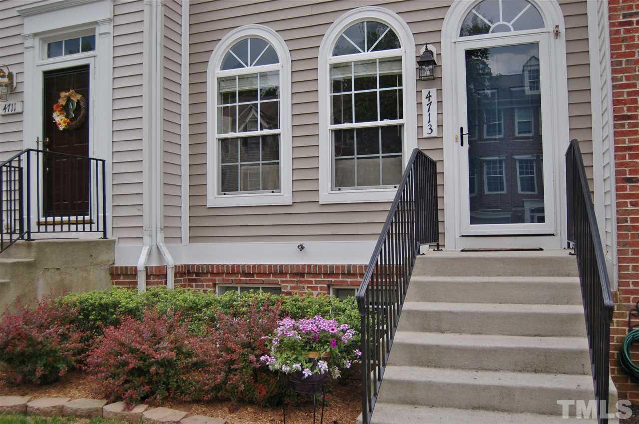 4713 Longhill Lane Raleigh, NC 27612 - Photo 2 of 18 a front view of a house with a yard and potted plants