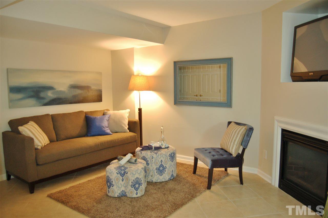 4713 Longhill Lane Raleigh, NC 27612 - Photo 12 of 18 a living room with furniture and a fireplace