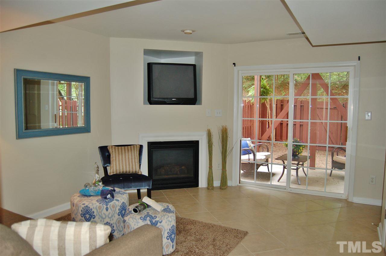 4713 Longhill Lane Raleigh, NC 27612 - Photo 13 of 18 a living room with furniture and a fireplace