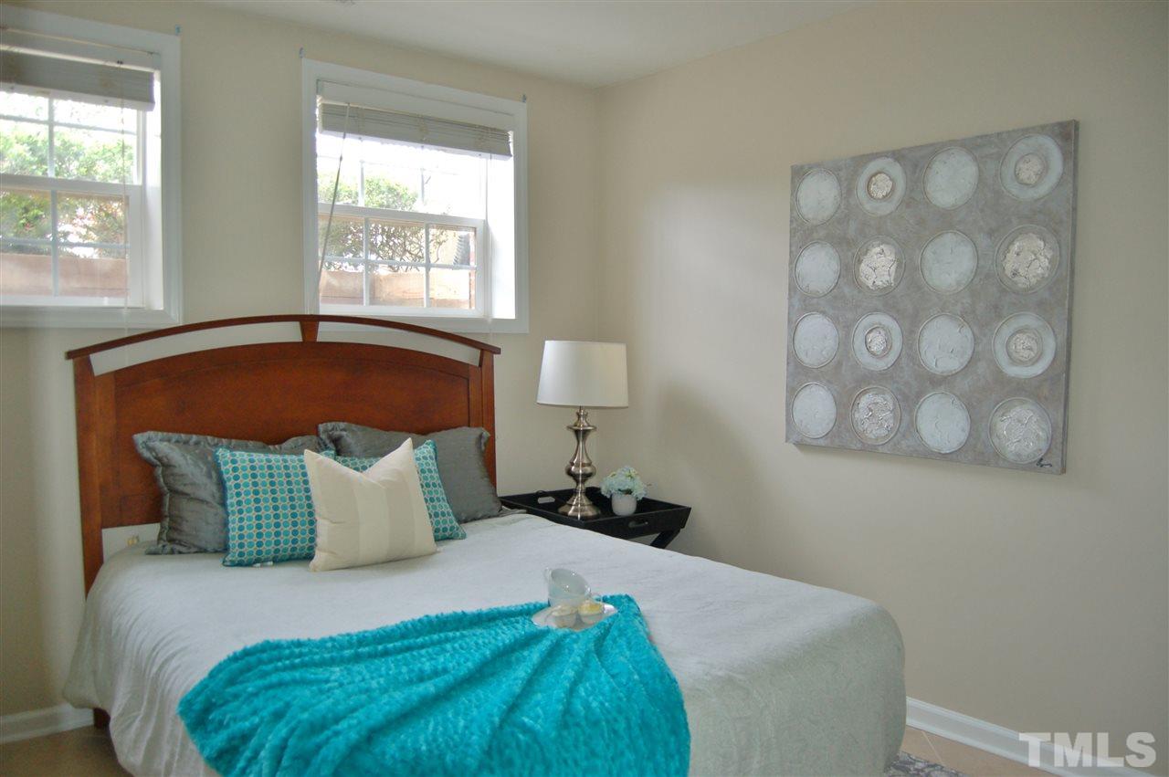 4713 Longhill Lane Raleigh, NC 27612 - Photo 14 of 18 a bedroom with a bed and window