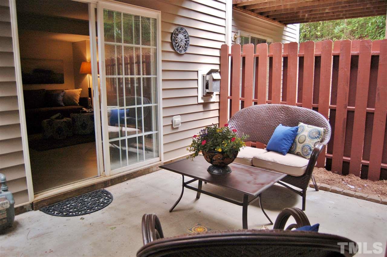 4713 Longhill Lane Raleigh, NC 27612 - Photo 15 of 18 a patio with a table and chairs and potted plants